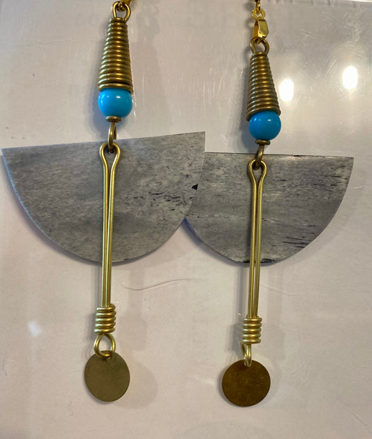 Earrings with gold elements, turquoise beads, and half-circle shapes on a white background