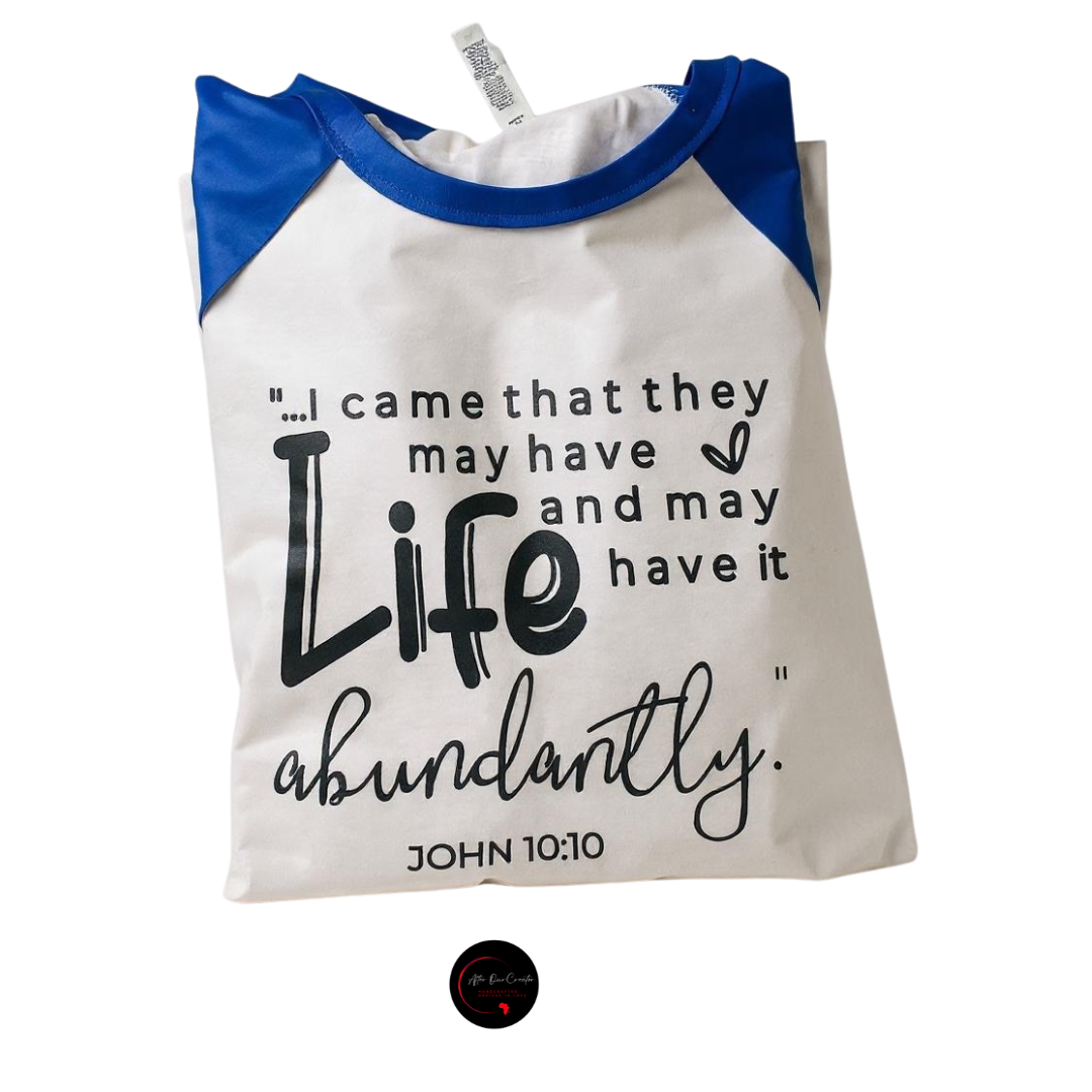 White and blue shirt with text 'Life abundantly' on a white background