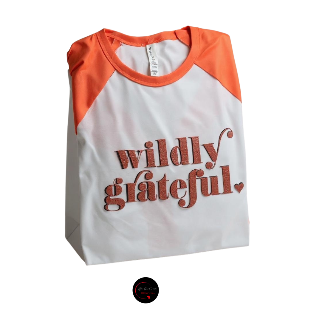 White and orange shirt with 'wildly grateful' text on a white background