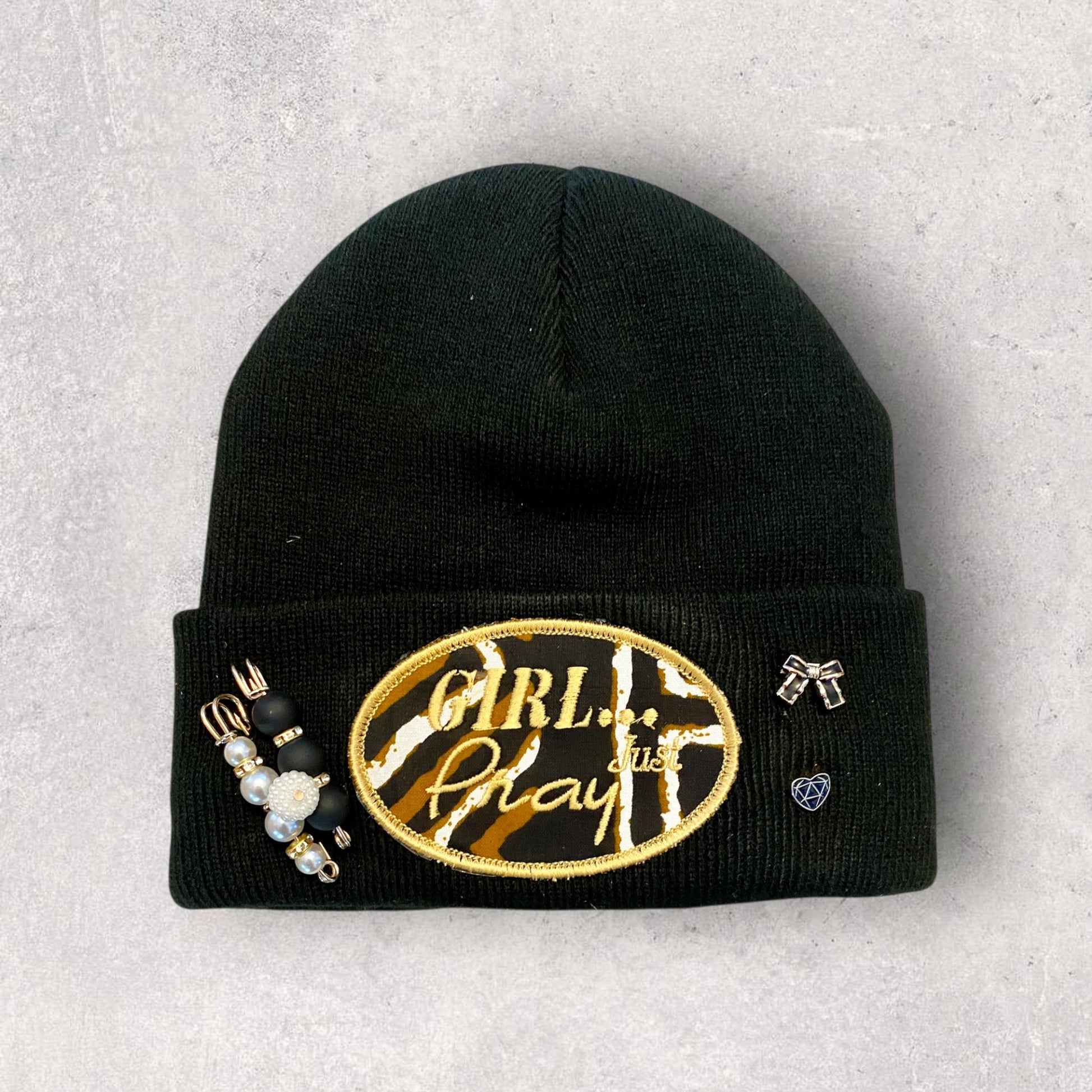 Black beanie with 'Girl Boss' embroidery on a gray background