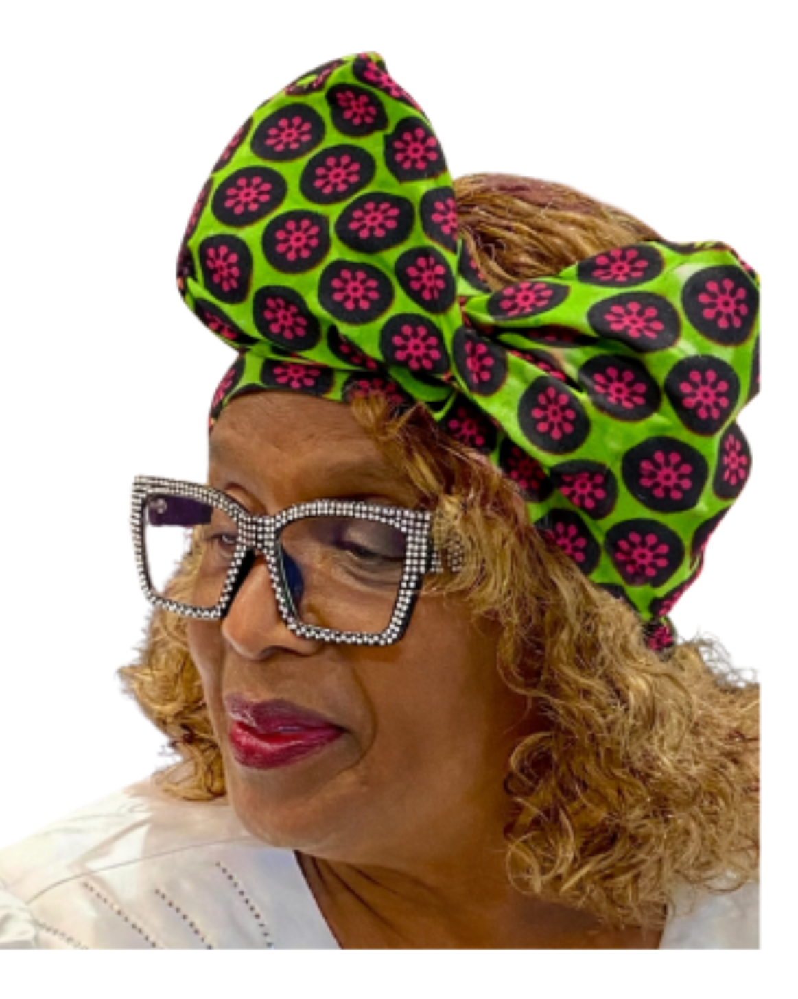 Woman wearing a green and pink patterned headscarf with decorative glasses on a white background