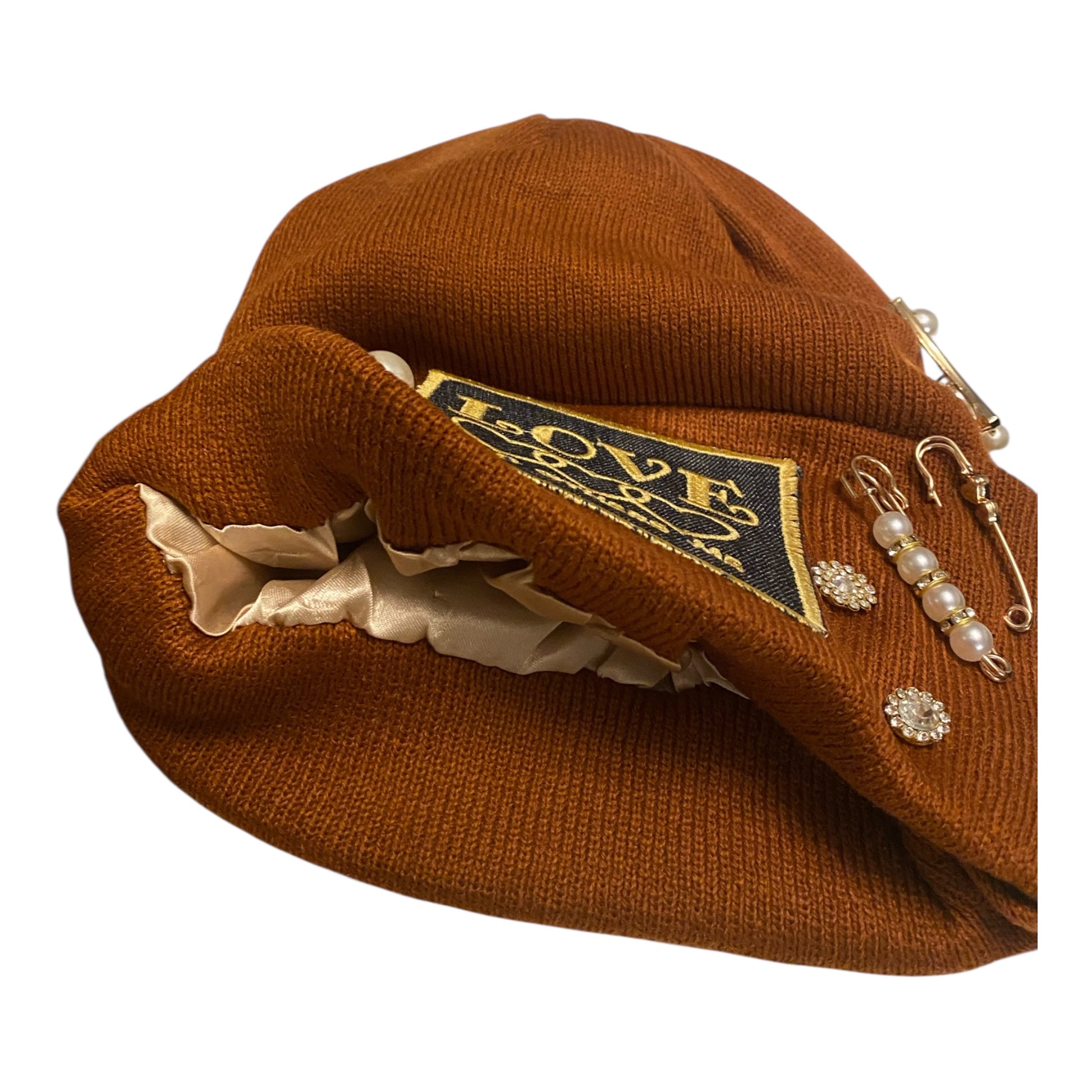 Brown beret with decorative elements on a white background